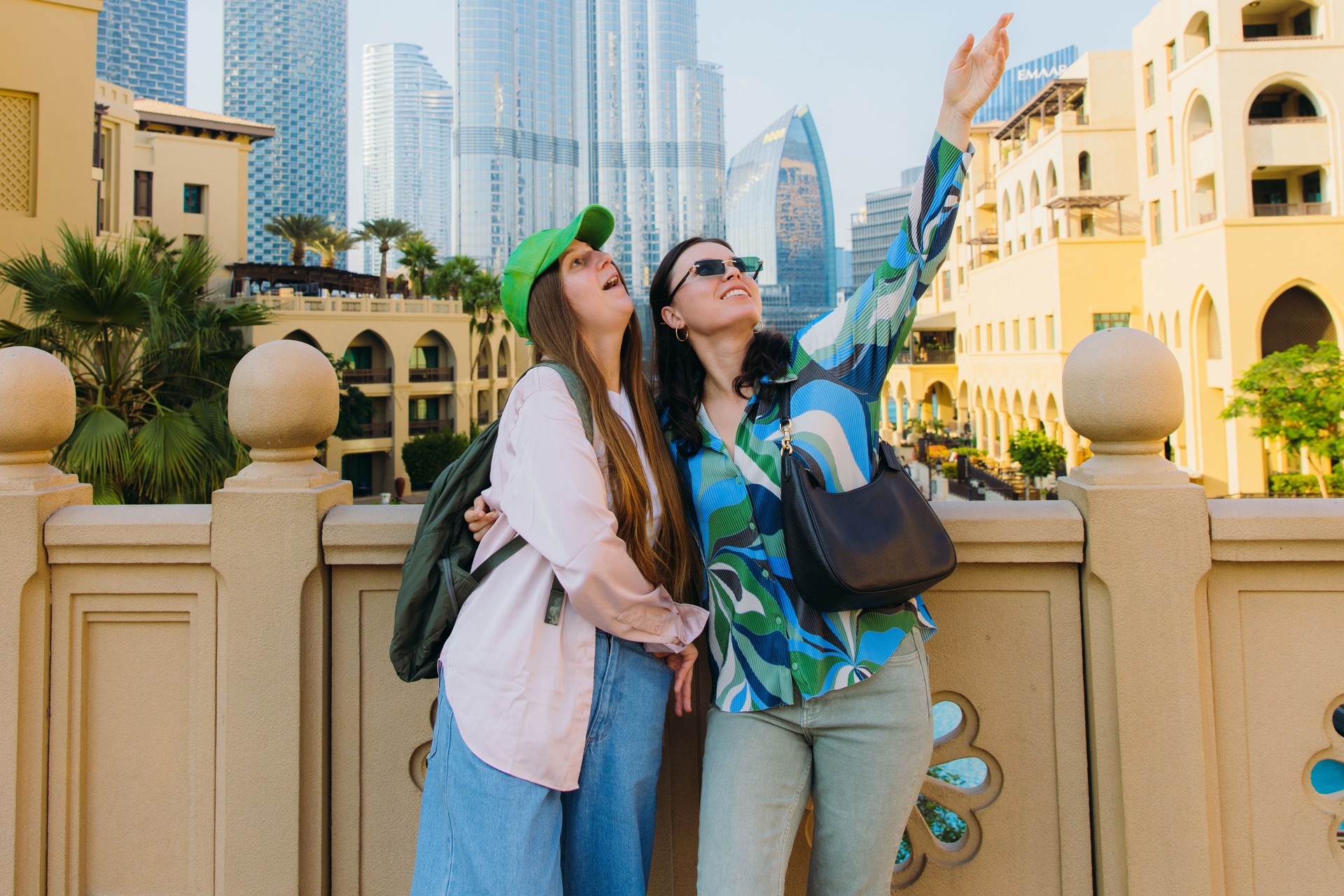 Two Happy Women Friends Tourists Exploring Dubai Downtown