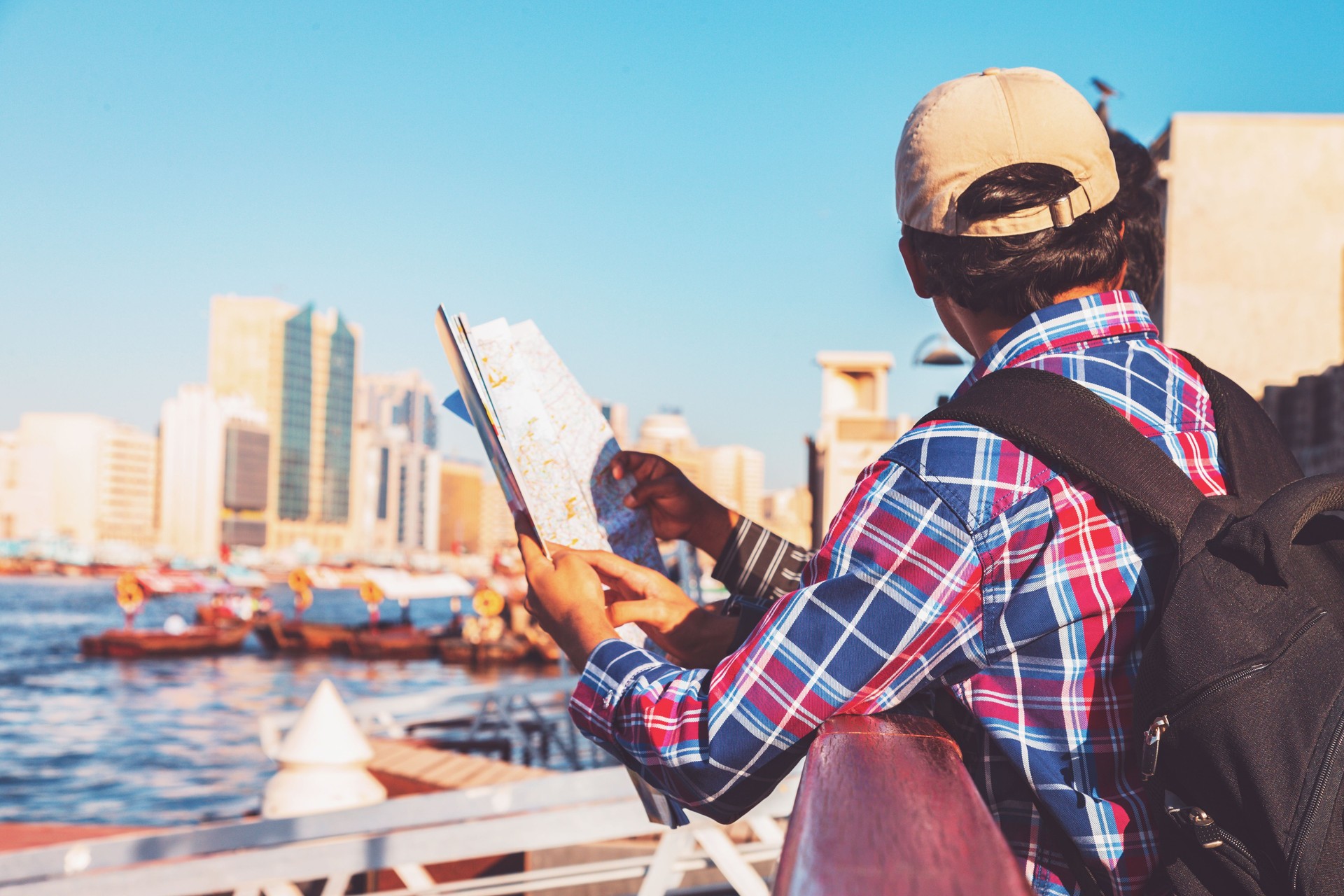 Friends visiting Dubai, looking for tourist attractions on the map